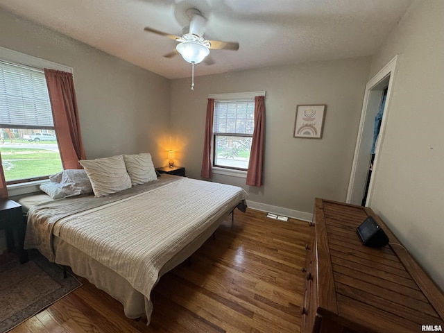 2139 10th St, East Moline, IL 61244 - bedroom featuring wood finished floors, baseboards, and a ceiling fan