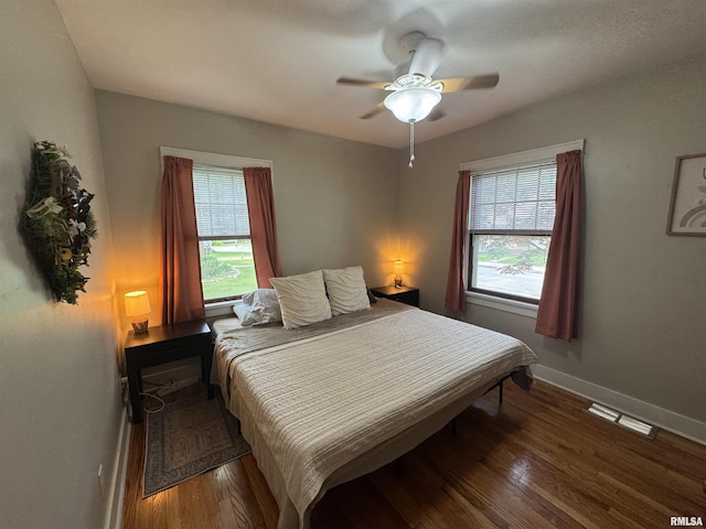 2139 10th St, East Moline, IL 61244 - bedroom featuring multiple windows, wood finished floors, baseboards, and ceiling fan