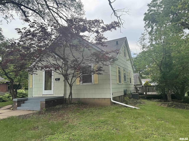 2139 10th St, East Moline, IL 61244 - view of front facade with a front yard, roof with shingles, and central air condition unit