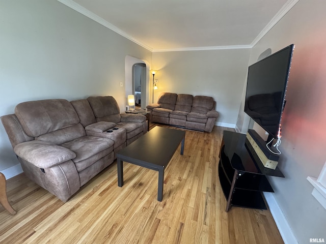 2139 10th St, East Moline, IL 61244 - living room featuring arched walkways, light wood-style flooring, crown molding, and baseboards