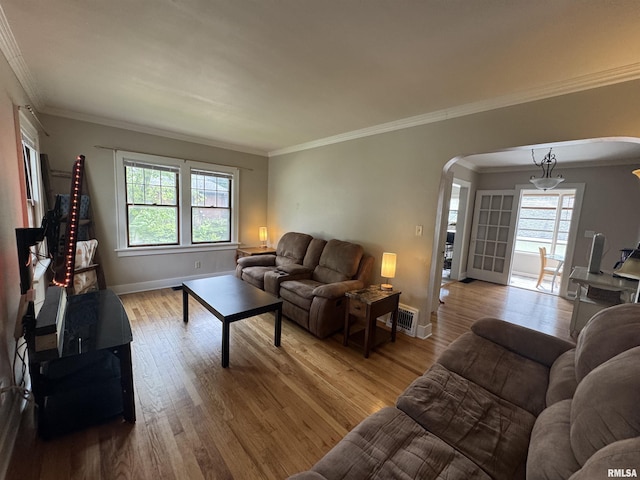 2139 10th St, East Moline, IL 61244 - living area with arched walkways, healthy amount of natural light, light wood finished floors, and crown molding