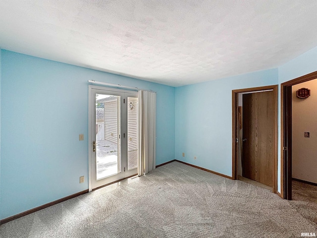 2347 W Lombard St, Davenport, IA 52804 - unfurnished bedroom with access to outside, carpet, a textured ceiling, and baseboards