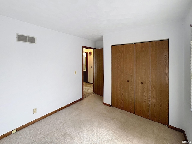 2347 W Lombard St, Davenport, IA 52804 - unfurnished bedroom featuring light colored carpet, a closet, and baseboards
