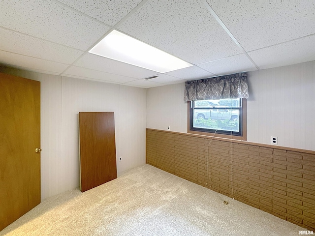 2347 W Lombard St, Davenport, IA 52804 - spare room with a drop ceiling, carpet floors, and wooden walls
