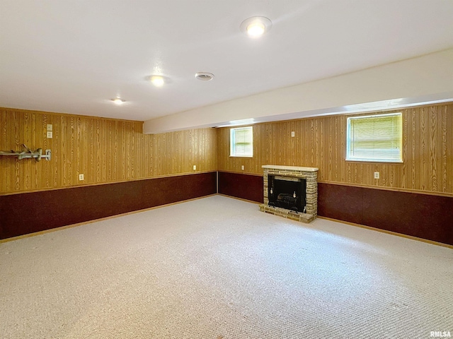 2347 W Lombard St, Davenport, IA 52804 - basement with light carpet, a fireplace with raised hearth, and wooden walls