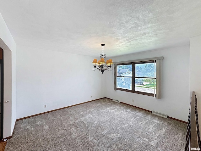 2347 W Lombard St, Davenport, IA 52804 - carpeted spare room with a chandelier, baseboards, and a textured ceiling