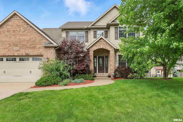 5518 Julie Ann Rd, Bettendorf, IA 52722 - craftsman-style house with a front yard, a garage, concrete driveway, brick siding, and a shingled roof