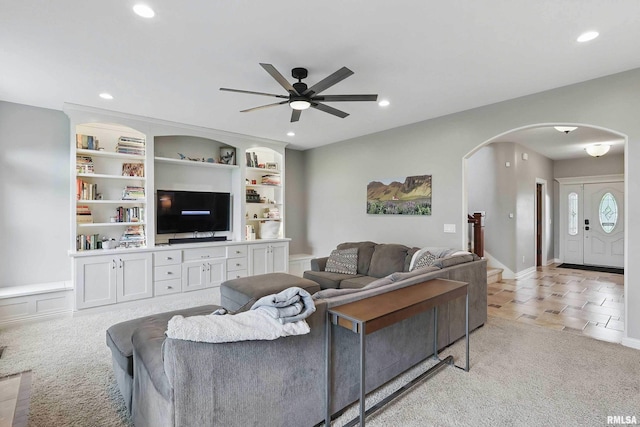 5518 Julie Ann Rd, Bettendorf, IA 52722 - living room with arched walkways, light colored carpet, ceiling fan, recessed lighting, and built in shelves