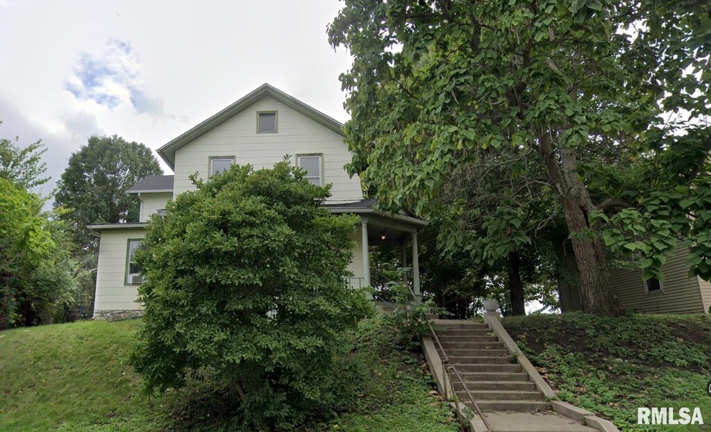 421 E 7th St, Davenport, IA 52803 - view of property hidden behind natural elements with stairway and a front lawn