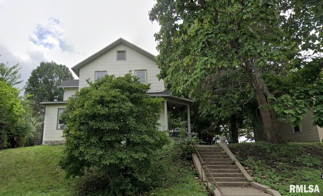 421 E 7th St, Davenport, IA 52803 - view of property hidden behind natural elements with stairway and a front lawn