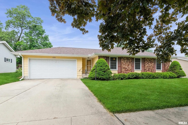 109 12th Ave, De Witt, IA 52742 - ranch-style house featuring driveway, a front yard, and an attached garage