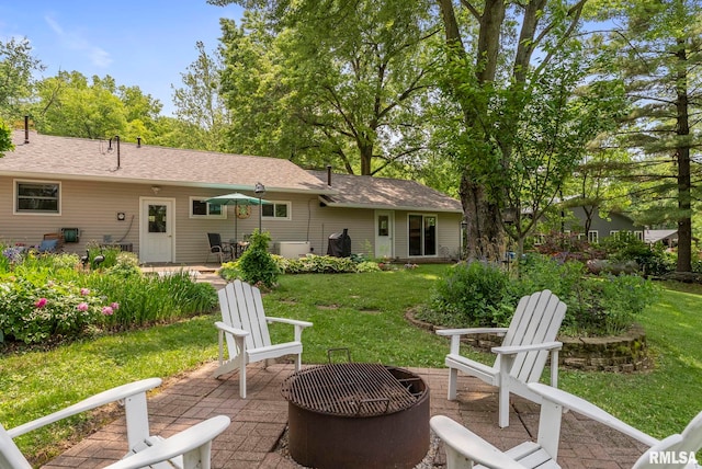 11 Shady Ln, Geneseo, IL 61254 - rear view of house featuring a patio, a yard, a fire pit, and roof with shingles