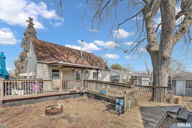 1519 W Columbia Ave, Davenport, IA 52804 - back of property with an outdoor fire pit, a deck, and a shingled roof
