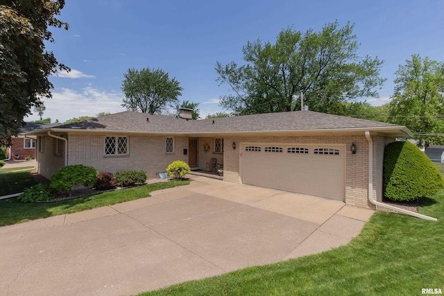 2737 28th Ave, Rock Island, IL 61201 - ranch-style house with brick siding, an attached garage, driveway, and a chimney