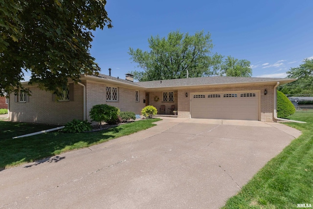 2737 28th Ave, Rock Island, IL 61201 - ranch-style house featuring an attached garage, brick siding, concrete driveway, a front lawn, and a chimney