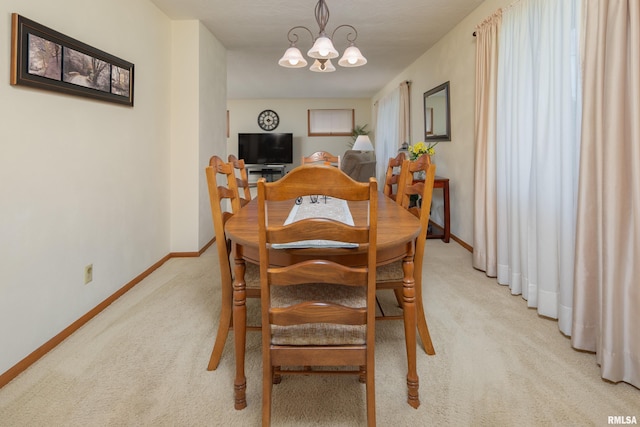 2737 28th Ave, Rock Island, IL 61201 - dining room with light colored carpet, a chandelier, and baseboards