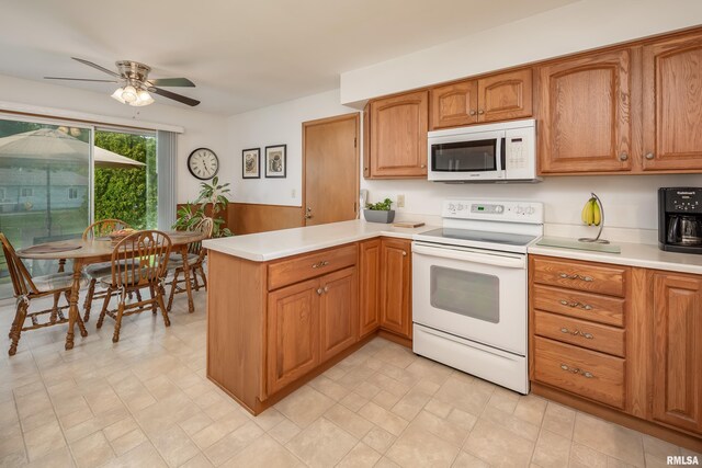 2737 28th Ave, Rock Island, IL 61201 - kitchen with white appliances, a peninsula, light countertops, a ceiling fan, and brown cabinetry