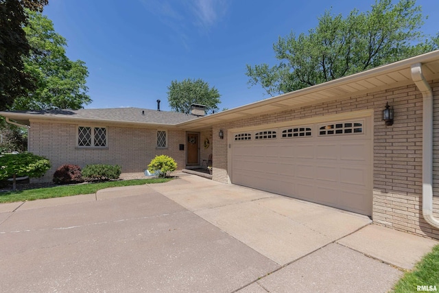2737 28th Ave, Rock Island, IL 61201 - ranch-style home with brick siding, an attached garage, concrete driveway, and a chimney