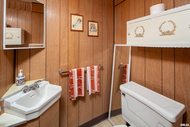 2737 28th Ave, Rock Island, IL 61201 - bathroom featuring a sink, wooden walls, and toilet