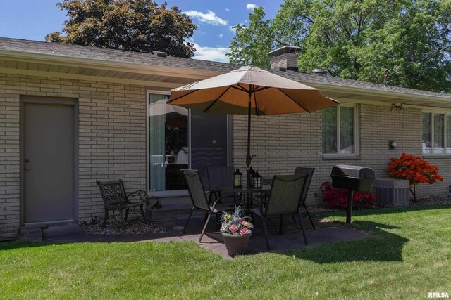 2737 28th Ave, Rock Island, IL 61201 - back of property with brick siding, a yard, cooling unit, a patio, and roof with shingles