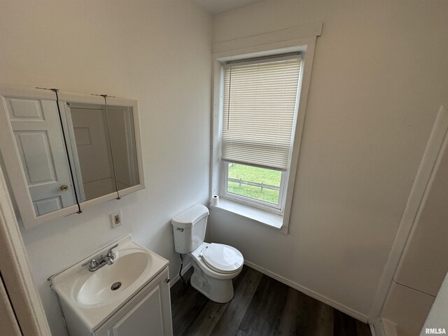 431 N 5th St, Quincy, IL 62301 - bathroom featuring toilet, vanity, wood finished floors, and baseboards