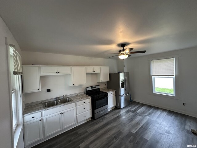 431 N 5th St, Quincy, IL 62301 - kitchen featuring appliances with stainless steel finishes, a sink, white cabinets, dark wood finished floors, and ceiling fan