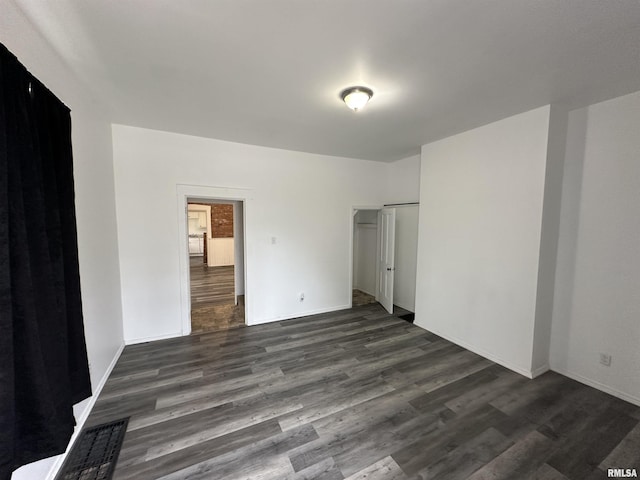 431 N 5th St, Quincy, IL 62301 - unfurnished bedroom featuring dark wood-type flooring, a closet, and baseboards