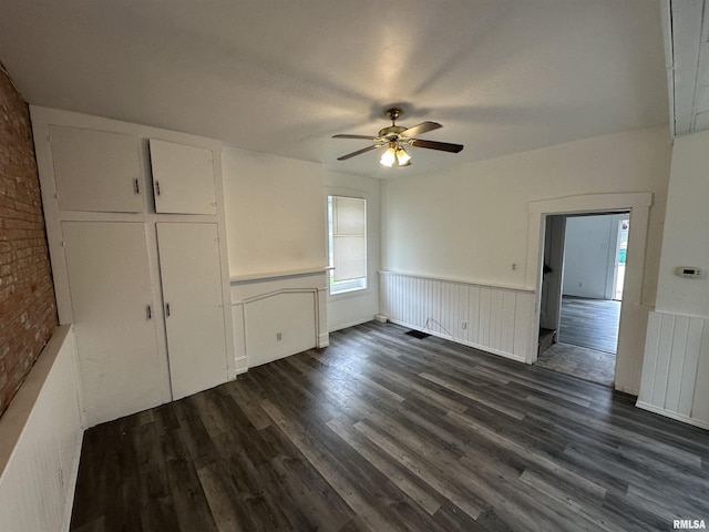 431 N 5th St, Quincy, IL 62301 - unfurnished dining area with a wainscoted wall, a ceiling fan, and dark wood-type flooring