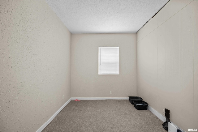 2734 Bridge Ave, Davenport, IA 52803 - empty room with carpet, a textured ceiling, baseboards, and a textured wall