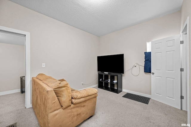 2734 Bridge Ave, Davenport, IA 52803 - carpeted living room with baseboards and a textured ceiling