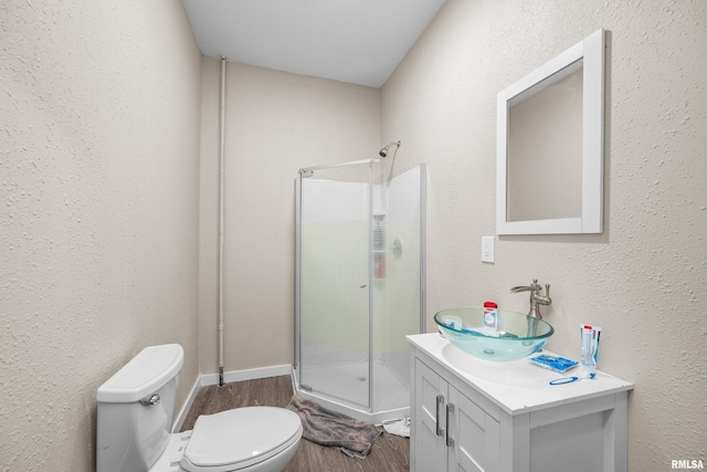 2734 Bridge Ave, Davenport, IA 52803 - bathroom with a stall shower, toilet, wood finished floors, and vanity