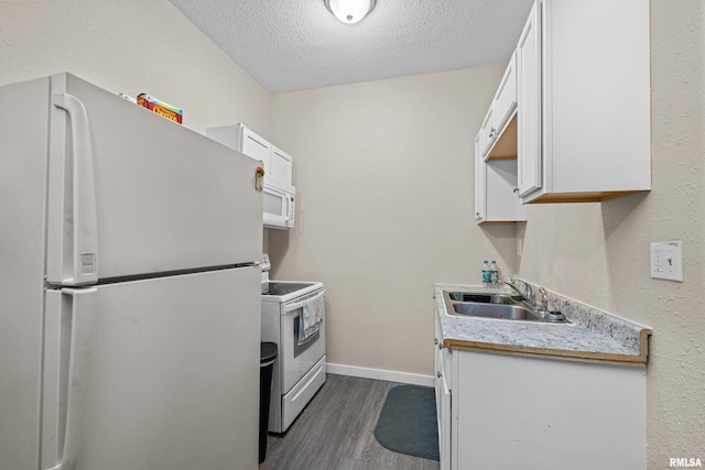 2734 Bridge Ave, Davenport, IA 52803 - kitchen with white appliances, a sink, dark wood-type flooring, baseboards, and a textured ceiling