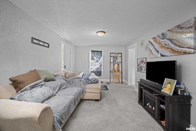 2734 Bridge Ave, Davenport, IA 52803 - carpeted living room with a textured ceiling and baseboards