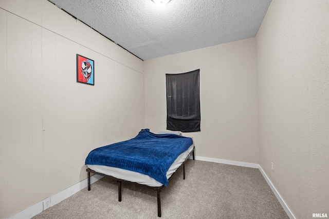2734 Bridge Ave, Davenport, IA 52803 - bedroom featuring a textured ceiling, carpet, and baseboards