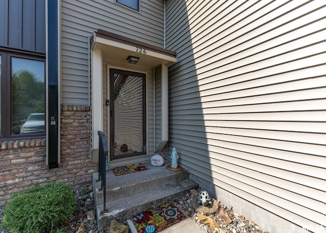 726 51st Ave Unit 20, East Moline, IL 61244 - doorway to property featuring board and batten siding