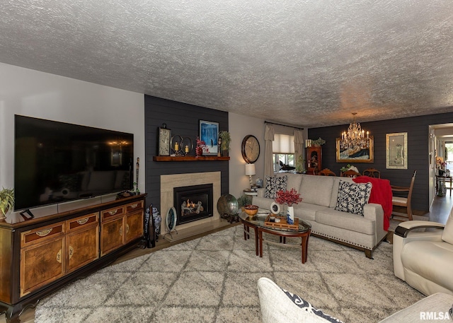726 51st Ave Unit 20, East Moline, IL 61244 - living area featuring a chandelier, a textured ceiling, a fireplace, and plenty of natural light