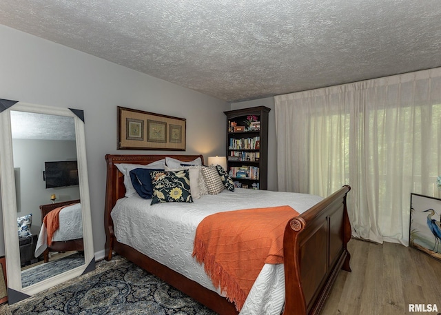 726 51st Ave Unit 20, East Moline, IL 61244 - bedroom with wood finished floors and a textured ceiling