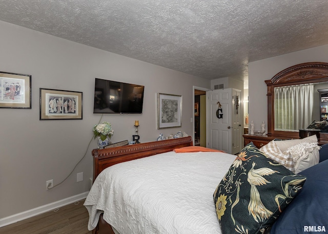 726 51st Ave Unit 20, East Moline, IL 61244 - bedroom with wood finished floors, baseboards, and a textured ceiling