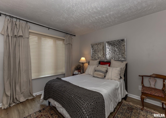 726 51st Ave Unit 20, East Moline, IL 61244 - bedroom featuring a textured ceiling, wood finished floors, and baseboards