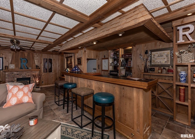 726 51st Ave Unit 20, East Moline, IL 61244 - indoor dry bar with wood walls, a ceiling fan, and a brick fireplace
