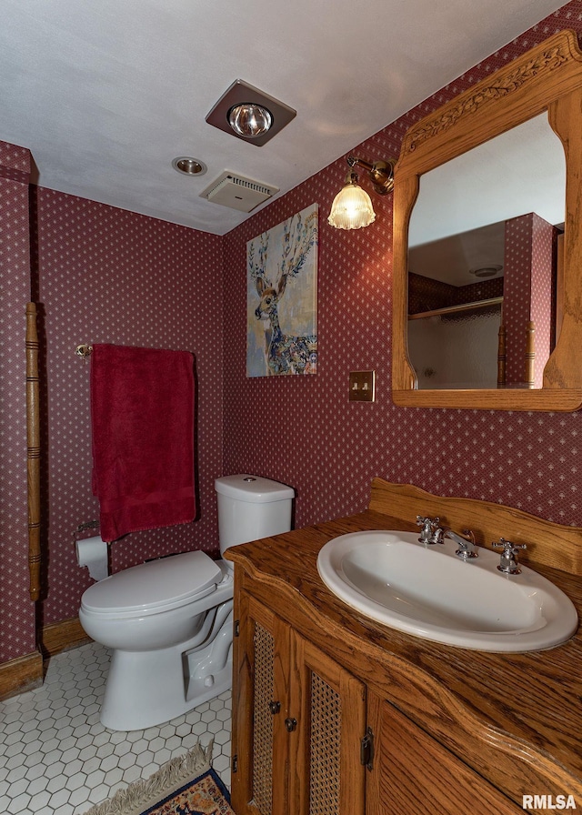 726 51st Ave Unit 20, East Moline, IL 61244 - bathroom featuring toilet, vanity, wallpapered walls, and a shower