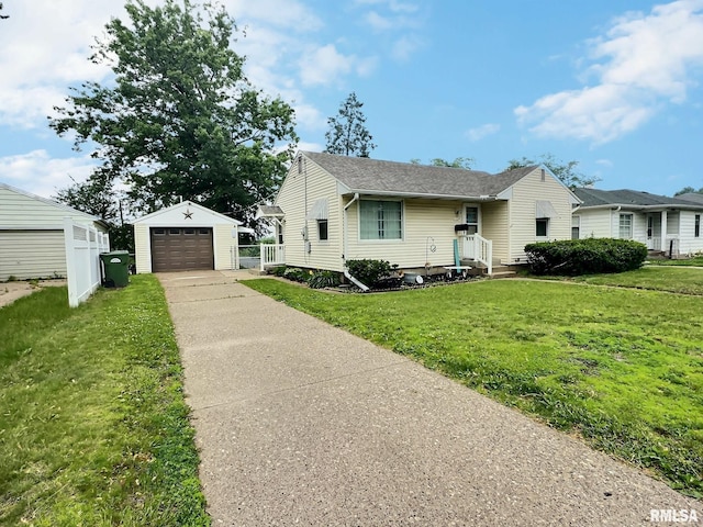 1324 Grandview Dr, Clinton, IA 52732 - view of front of property with driveway, an outbuilding, a detached garage, and a shingled roof