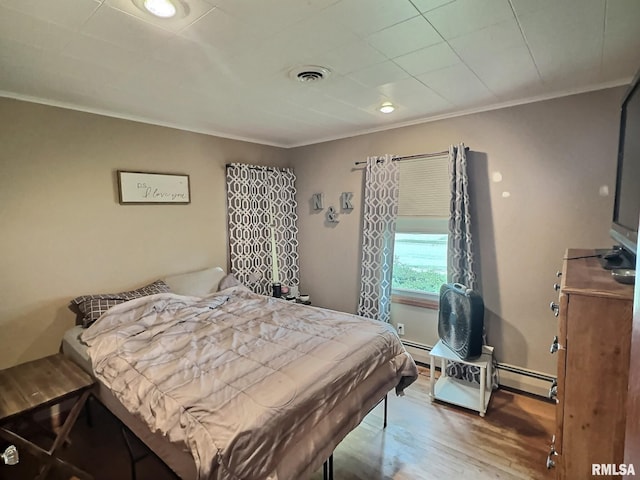 1324 Grandview Dr, Clinton, IA 52732 - bedroom featuring crown molding, wood finished floors, and a baseboard radiator