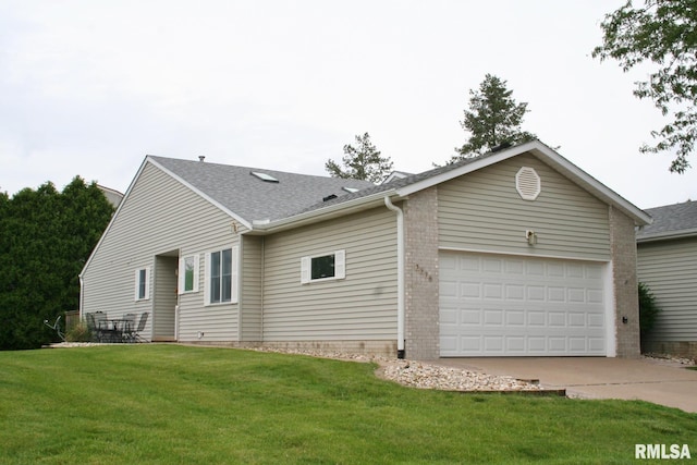 3996 Partridge Cir, Bettendorf, IA 52722 - view of home's exterior featuring an attached garage, driveway, a yard, and roof with shingles