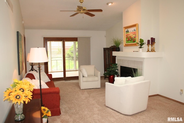 3996 Partridge Cir, Bettendorf, IA 52722 - living area featuring lofted ceiling, carpet, a tile fireplace, ceiling fan, and baseboards