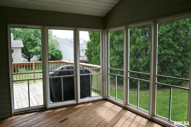 3996 Partridge Cir, Bettendorf, IA 52722 - unfurnished sunroom with lofted ceiling, wood-type flooring, and a wooden deck