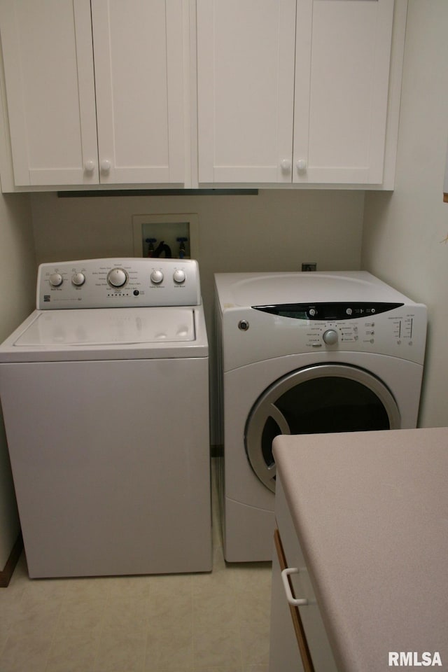3996 Partridge Cir, Bettendorf, IA 52722 - laundry room featuring washing machine and clothes dryer and cabinet space