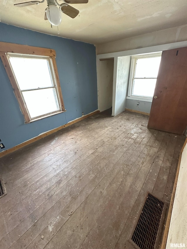 700 Cedar St, Muscatine, IA 52761 - unfurnished bedroom with wood-type flooring and a ceiling fan