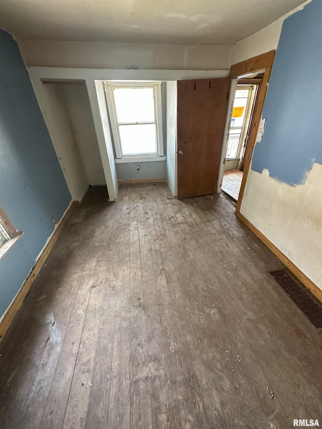 700 Cedar St, Muscatine, IA 52761 - unfurnished bedroom with wood-type flooring and baseboards