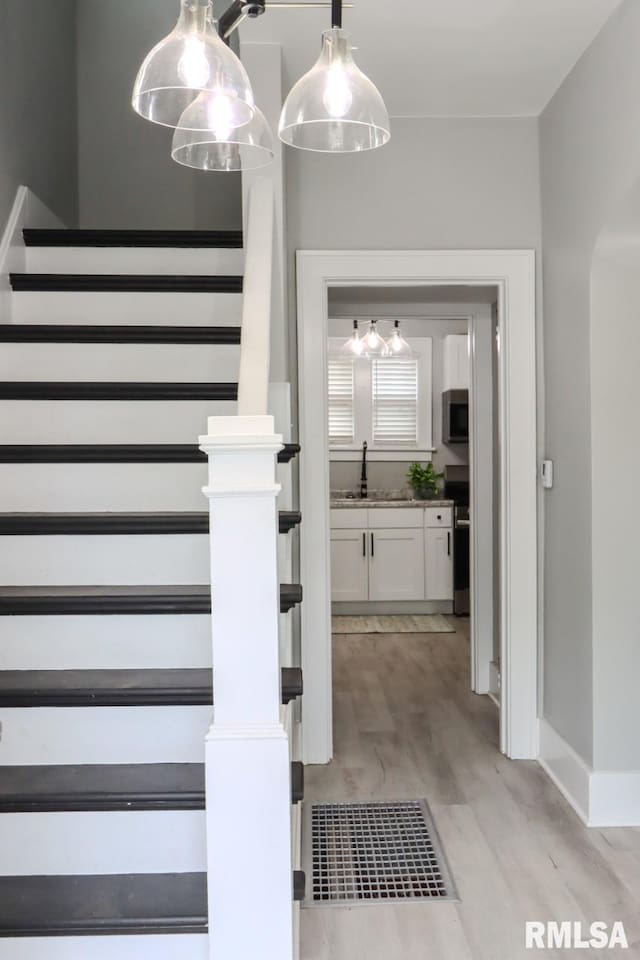 1617 Payson Ave, Quincy, IL 62301 - stairs featuring wood finished floors and baseboards